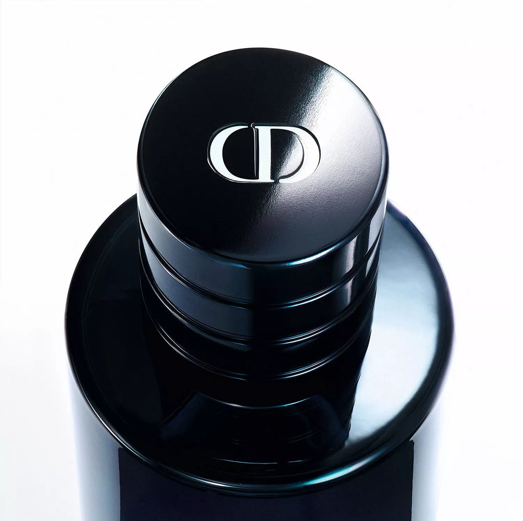Close-up of a black cosmetic container with a brand logo on a white background